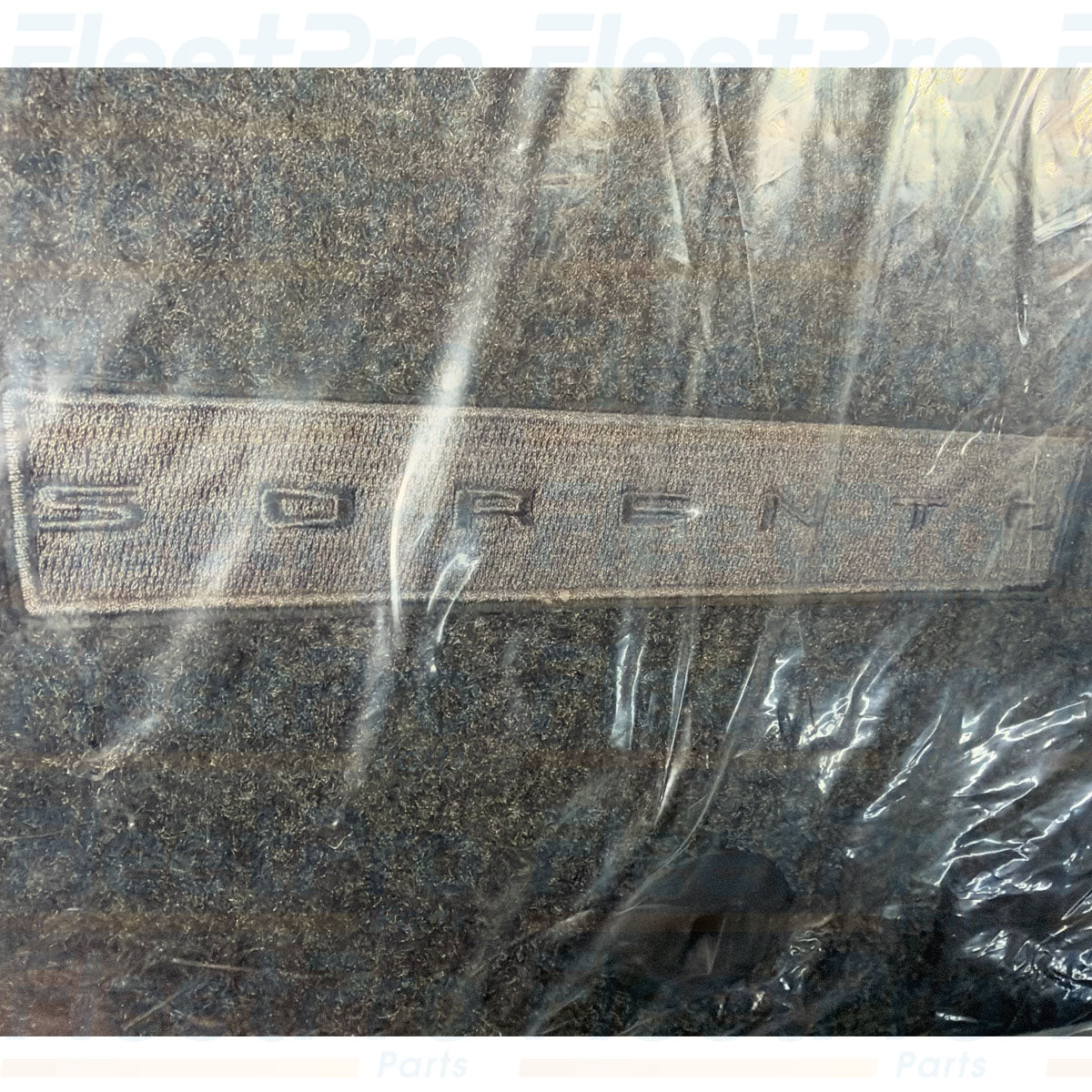 Detailed view of embroidered PHEV / Kia factory logo badging and edge binding on R5F14-AC000 mat