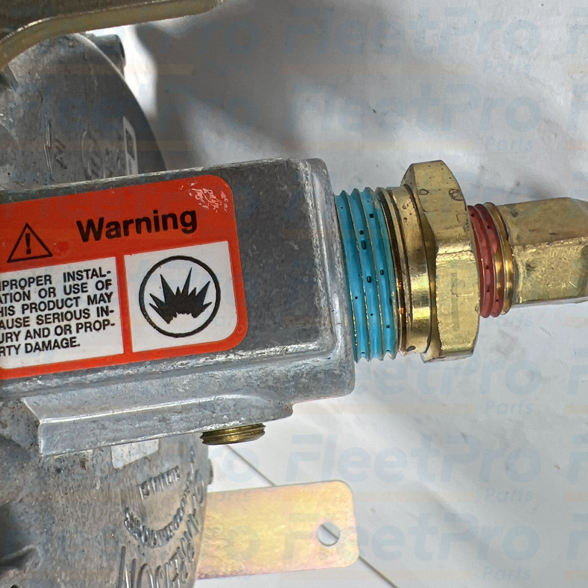 Pressure test port and adjustment screw housing detail on Onan 0148-1145 fuel regulator