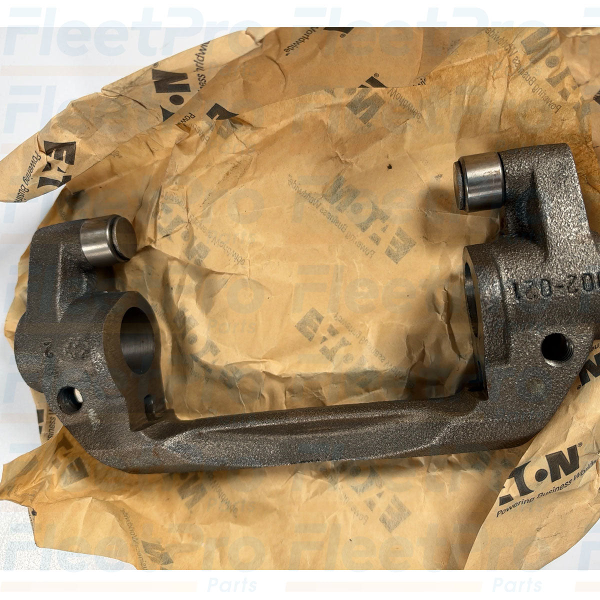 Close-up view of precision-ground roller contact pads on open box Eaton 3525689C2 release fork