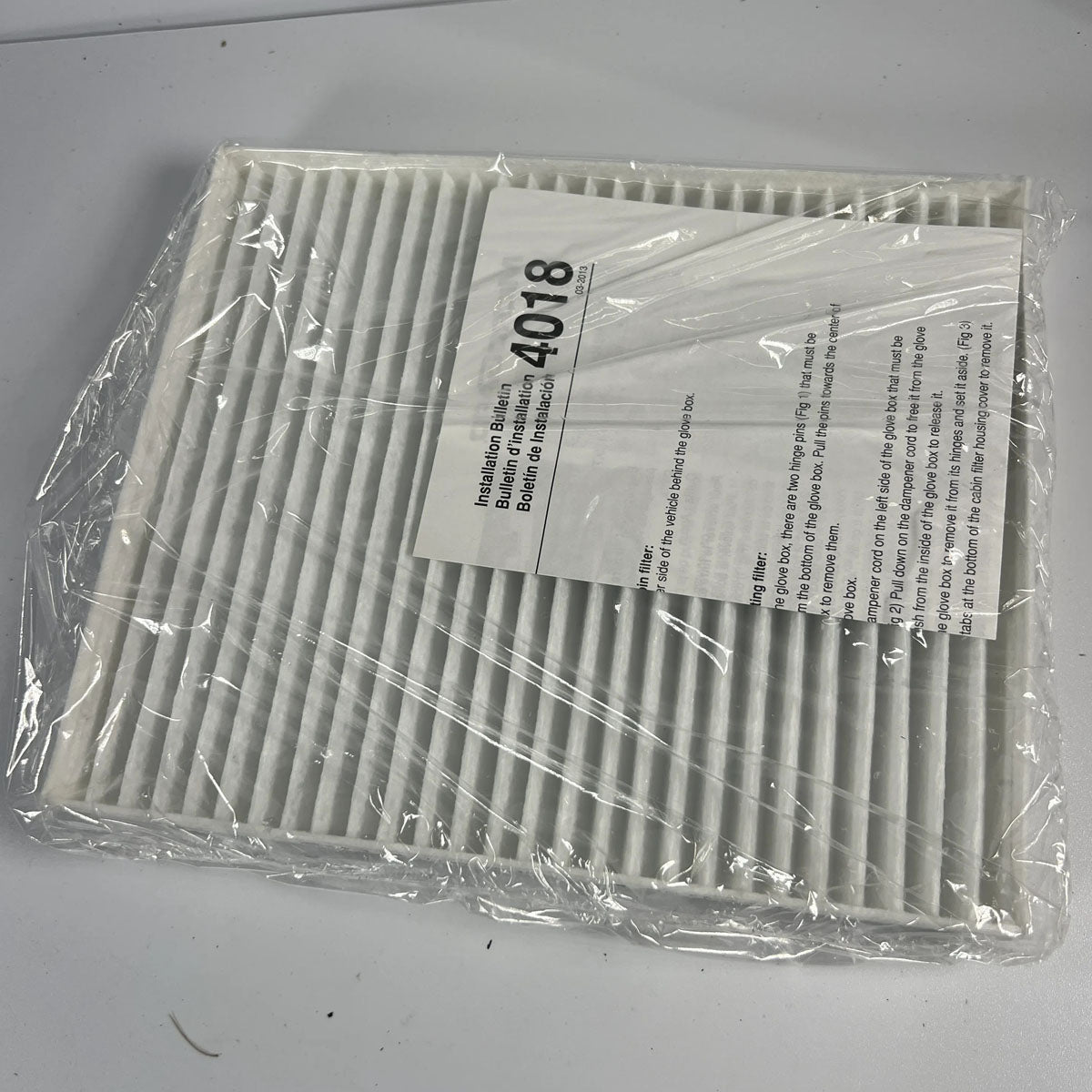 Microgard 4018 cabin air filter front view displaying white synthetic media