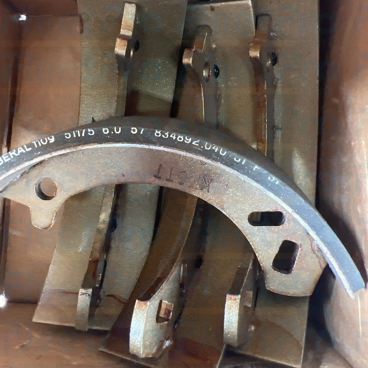 Close-up view of remaining friction lining material thickness on used Toro 84-8600 brake shoe